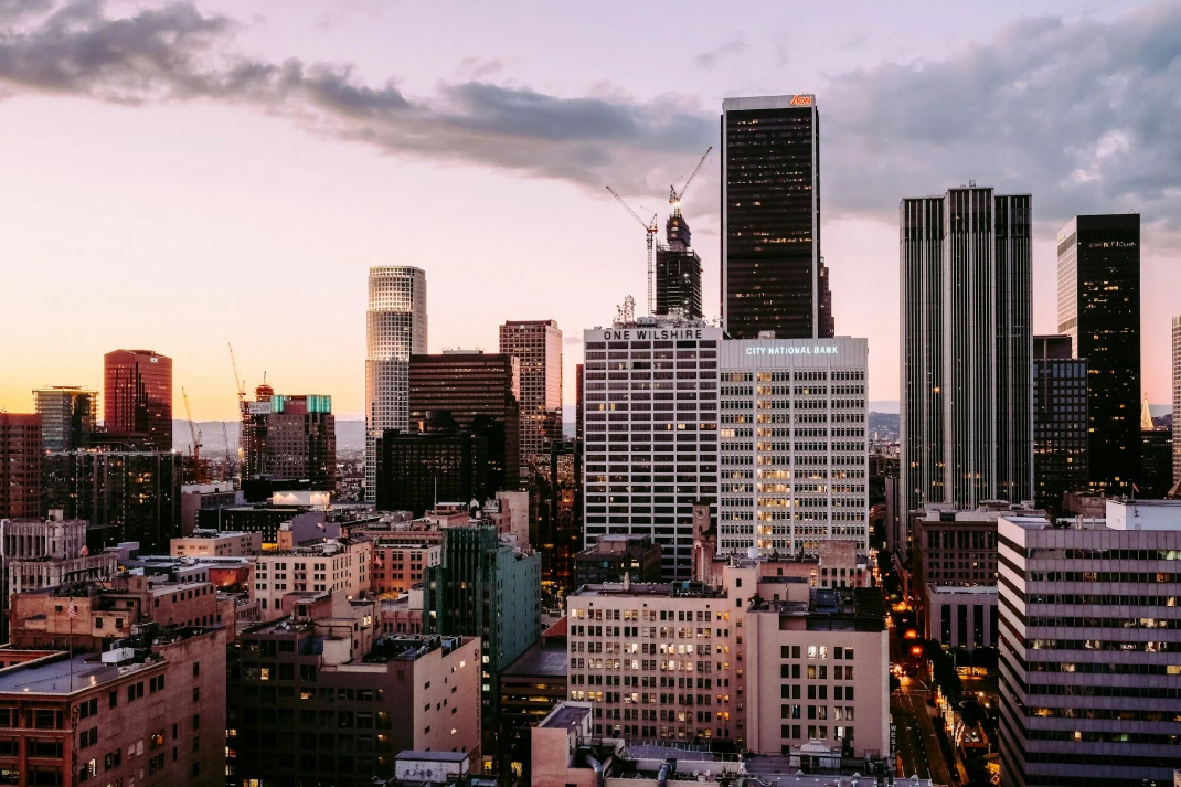 The One Wilshire building and surrounding skyscrapers in the Los Angeles skyline at dusk